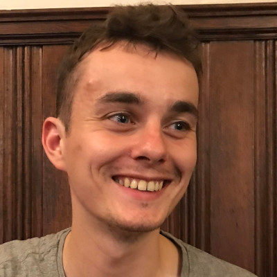 A photo of John, a young man. He is smiling.